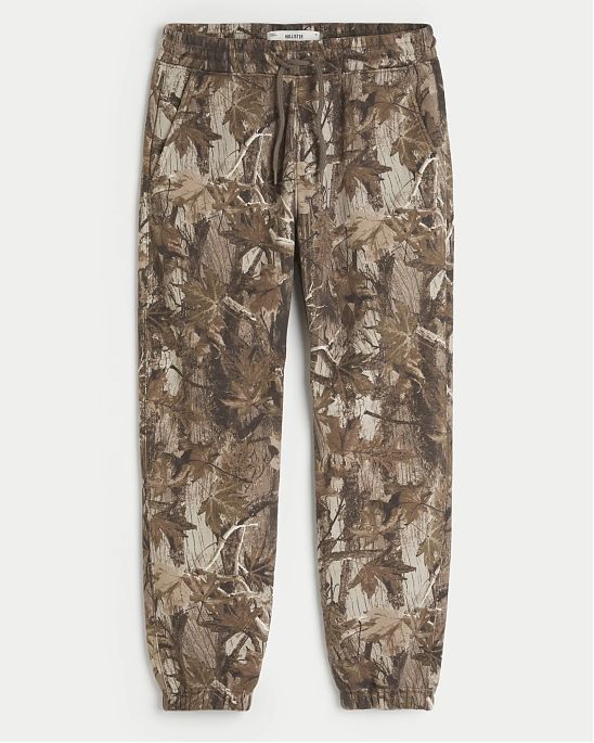 Moscow USA предлагает вам купить мужские джоггеры Hollister Relaxed Fleece Logo коричневого камуфляжного цвета с нашитым логотипом. Модель 07922. Бесплатная доставка по России, Москве и области, самовывоз.