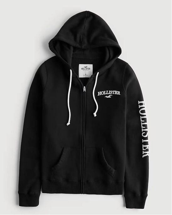 Женская толстовка с капюшоном на молнии  Hollister черного цвета с белой нашитой надписью и лого. Модель 06775. Подробное описание и цена товара. Доставка по России, Москве и Области от Moscow USA